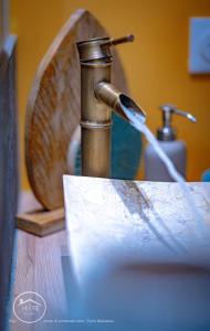 a sink with a faucet next to a mirror at Chic l Ascenseur l Terrasse centre ville in Chambéry +26 photos
