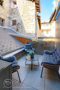 two chairs and a table on a patio at Chic & Spa l Ascenseur l Terrasse centre ville in Chambéry