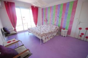 カンヌにあるPalm Beach Appartement Proche Merの紫の床のベッドルーム1室(ベッド1台付)
