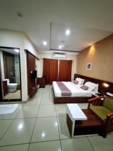 a hotel room with a bed and a living room at Emperorhotel in Jāmb