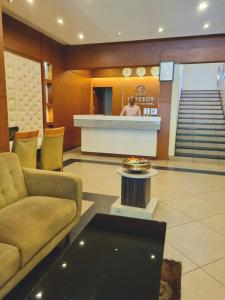 a lobby with a couch and a table in a building at Emperorhotel in Jāmb