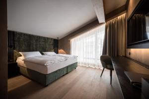 Postel nebo postele na pokoji v ubytování Hotel Cappella