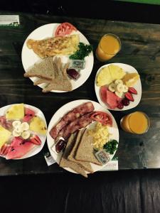 a group of plates of breakfast foods on a table at Hotel & Hostel Sloth Backpackers in Monteverde Costa Rica