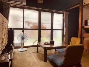 a living room with a table and a window at like living in a traditional Japanese house, Accessible! one group per day! in Hirakata