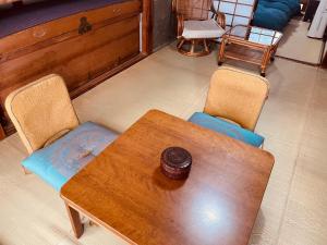 a dining room with a wooden table and chairs at like living in a traditional Japanese house, Accessible! one group per day! in Hirakata