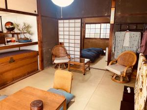 a living room with chairs and a table and a couch at like living in a traditional Japanese house, Accessible! one group per day! in Hirakata +39 photos