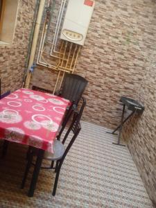 a table and chair sitting on a balcony at Home sweet home 2 bed with a living room in Batna