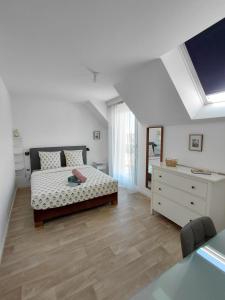 a bedroom with a bed and a dresser in it at Maison avec jardin privatif pour 4 a 7 personnes proche de la plage bonne source in Pornichet