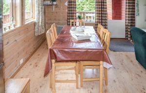 a dining room with a table and chairs at 3 Bedroom Gorgeous Home In Vikeså in Vikeså