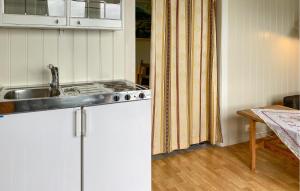 a kitchen with a sink and a stove at 1 Bedroom Amazing Home In Tingvoll in Tingvoll