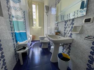 a blue and white bathroom with two toilets and a sink at Villa Del Prete in Nardò +41 photos