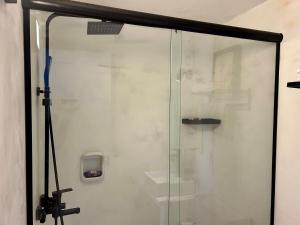 a shower with a glass door in a bathroom at Diseño y terraza en Punta del Este in Punta del Este +28 photos