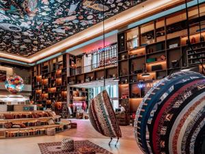 a store with a large room with a ceiling with a mural at 25hours Hotel Dubai One Central in Dubai