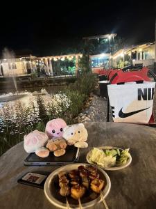 a table with two plates of food on top of it at Hug Wang Homestay in Ban Nong Chaeng