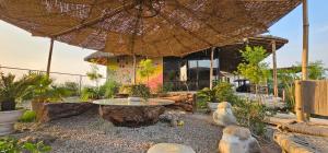 an outdoor patio with a table and an umbrella at The Cottage Core Village in Borās
