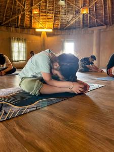 a woman laying on a rug on the floor at The Cottage Core Village in Borās