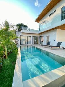 a swimming pool in the backyard of a house at Kohkohnut villa 3BR Villa with Private Pool in Bophut Near Fisherman in Amphoe Koh Samui