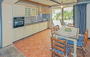 a kitchen with a table and chairs and a dining room at 1 Bedroom Gorgeous Apartment In Secovlje in Sečovlje