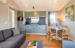 a living room with a couch and a table at Nice Home In Breukelen in Breukelen
