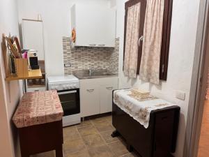 a small kitchen with a sink and a stove at Vals Peter's Home in Jerzu