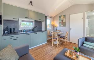 a kitchen and living room with a couch and a table at Nice Home In Breukelen in Breukelen