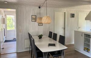 a dining room with a table and chairs at Holiday Home Småfolksvej Rømø Xii in Bolilmark