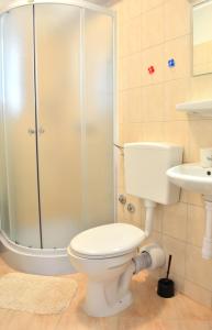a bathroom with a shower and a toilet and a sink at Apartments M&B in Podstrana