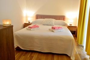 a bedroom with a bed with two pillows on it at Apartments M&B in Podstrana
