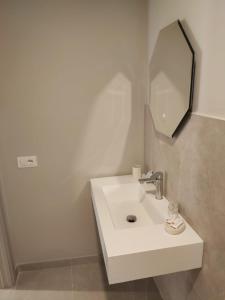a bathroom with a white sink and a mirror at Le volte nel borgo in Termoli