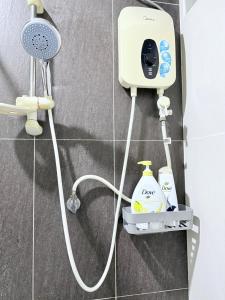 a shower with a shower head and a shower at Stylish Luxury Two Bedrooms Condo 1-6pax at D Secret Garden - Johor Bahru-Mid Valley-Paradigm Mall-Dato Onn-Setia Tropika-Kempas-UTM in Johor Bahru