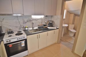 a small kitchen with a sink and a stove at Sweet Retreat in Dispilio +26 photos