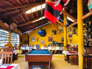 a restaurant with a pool table in the middle of a room at Hotel LE BOEUF in Mandriankeniheny