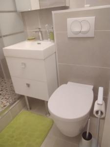 a bathroom with a white toilet and a sink at Bonite in Les Trois-Îlets