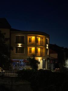 a lit up building with a balcony at night at Just a Dream in Troyan +84 photos