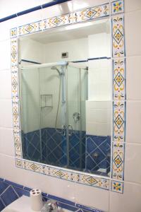 a bathroom with a shower and a mirror at B&B Amphisya in Roccella Ionica