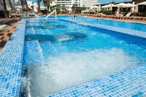 a large swimming pool with blue tiles on it at HD Parque Cristobal Tenerife in Playa de las Americas