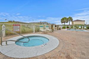a hot tub in the middle of a patio at Caribbean Resort 501A - Link To The Beach in Navarre