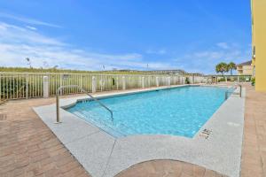 a swimming pool with a fence around it at Caribbean Resort 501A - Link To The Beach in Navarre