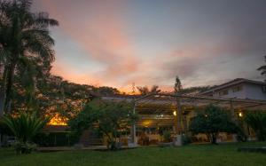 a house with a sunset in the background at El Lugar Boutique Hotel in Pereira