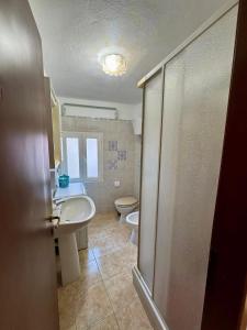 a bathroom with a sink and a toilet at Mediterranea Apartment in Agrigento