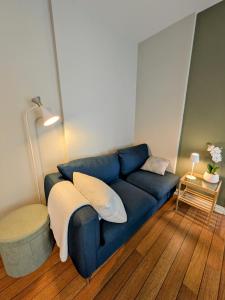 a blue couch sitting in a living room at Central and spacious 3-bedroom apartment in Mandal +12 photos