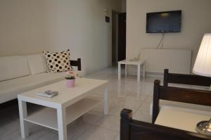 a living room with a couch and a table at Lordos Hotel Apts Limassol in Limassol