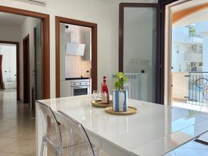 a kitchen with a white table and chairs at Holihome Mondo Serena in Tortoreto Lido