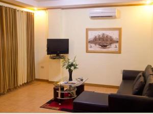 a living room with a couch and a tv at Casablanca Hotel Condominium Resort in Olongapo