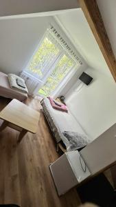 an attic room with a bed and a window at na rogu in Pobierowo