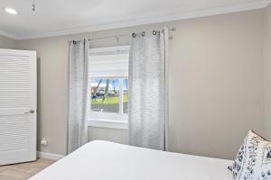 a bedroom with a bed and a window at Capri by the Gulf 122 in Destin