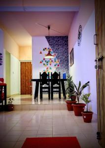 a dining room with a table and some plants at yercaud Happy valley cottage in Yercaud