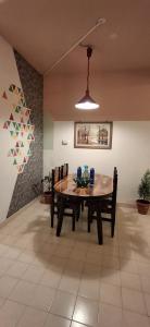 a dining room with a wooden table and chairs at yercaud Happy valley cottage in Yercaud +11 photos