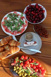 a table topped with plates of food and fruit at Pine House SPA pod Warszawą Jacuzzi, Sauna, Kominek, Grill, Las in Konstancin-Jeziorna