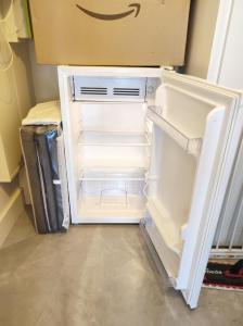 an empty refrigerator with its door open in a room at Villa et Spa in Pornic